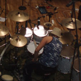 Magnús Freyr setting his drums up at Studio Sundlaugin, wide picture of the studio floor.